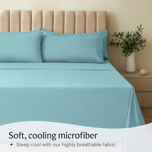 a bed with blue sheets and pillows with text: 'Soft, cooling microfiber Sleep cool with our highly breathable fabric'