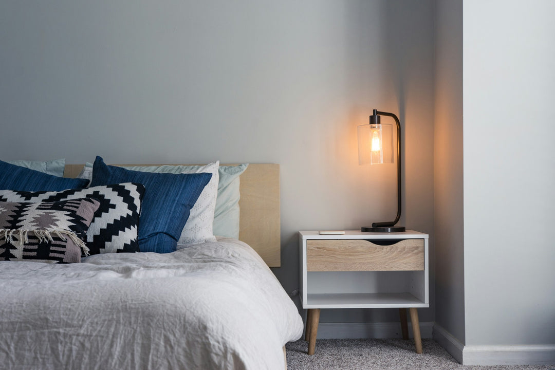Three luxury bedding fabric swatches showing percale, sateen, and linen weave textures in warm editorial light
