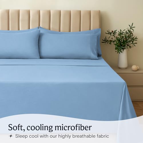 a bed with blue sheets and a plant in a vase with text: 'Soft, cooling microfiber Sleep cool with our highly breathable fabric'