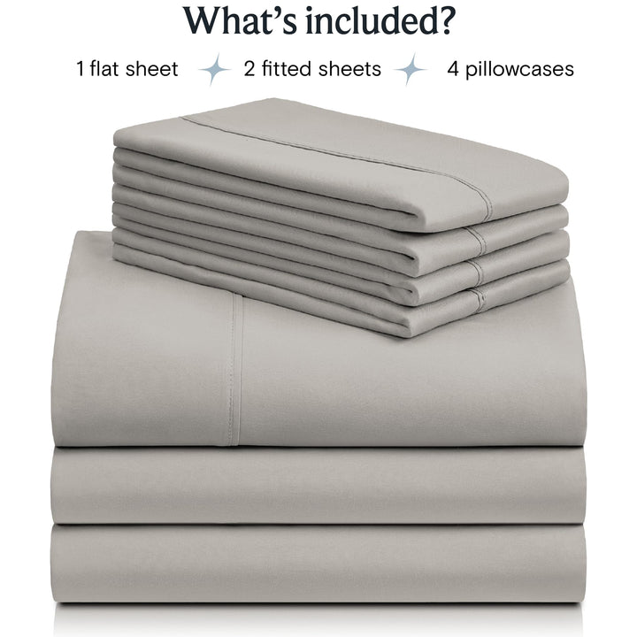 a stack of grey sheets with text: 'What's included? 1 flat sheet 2 fitted sheets 4 pillowcases'