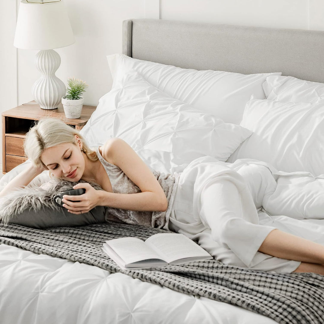 a person lying on a bed holding a phone
