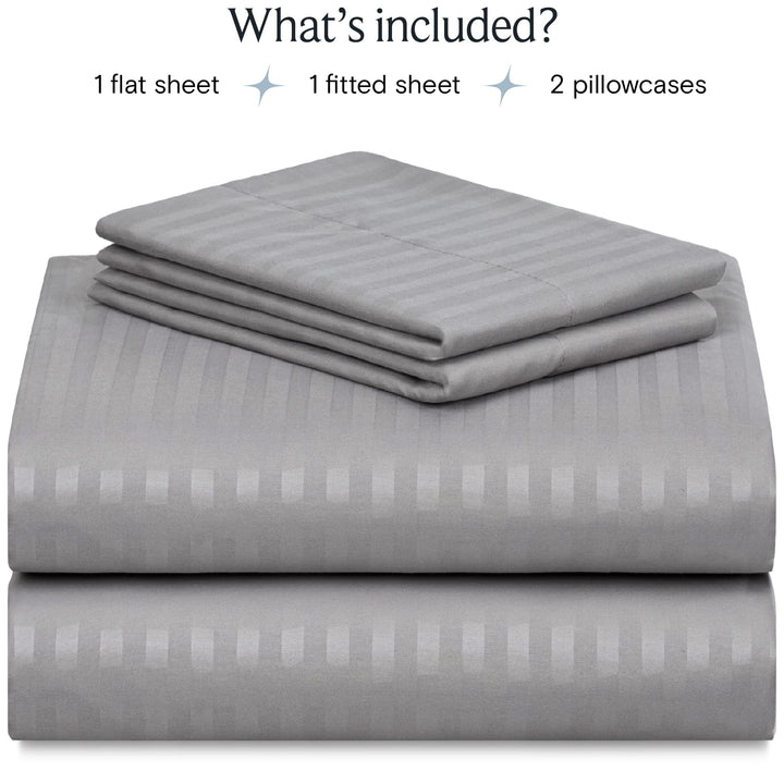 a stack of grey sheets with text: 'What's included? 1 flat sheet 1 fitted sheet 2 pillowcases'