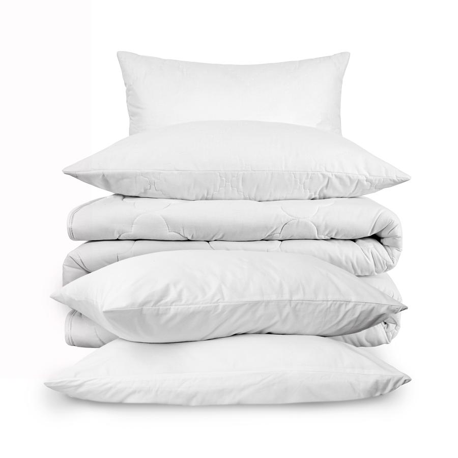 a stack of white pillows and blankets