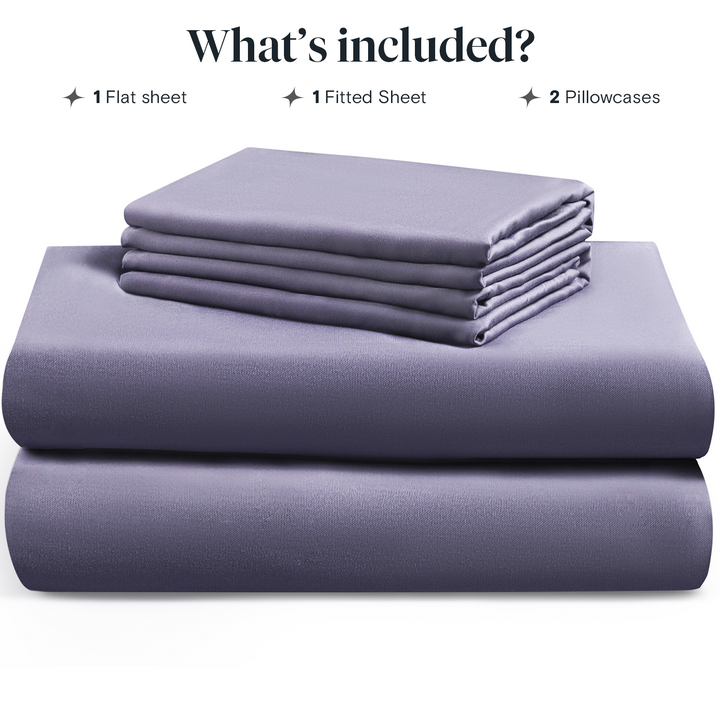 a stack of purple sheets with text: 'What's included? 1 Flat sheet 1 Fitted Sheet 2 Pillowcases'