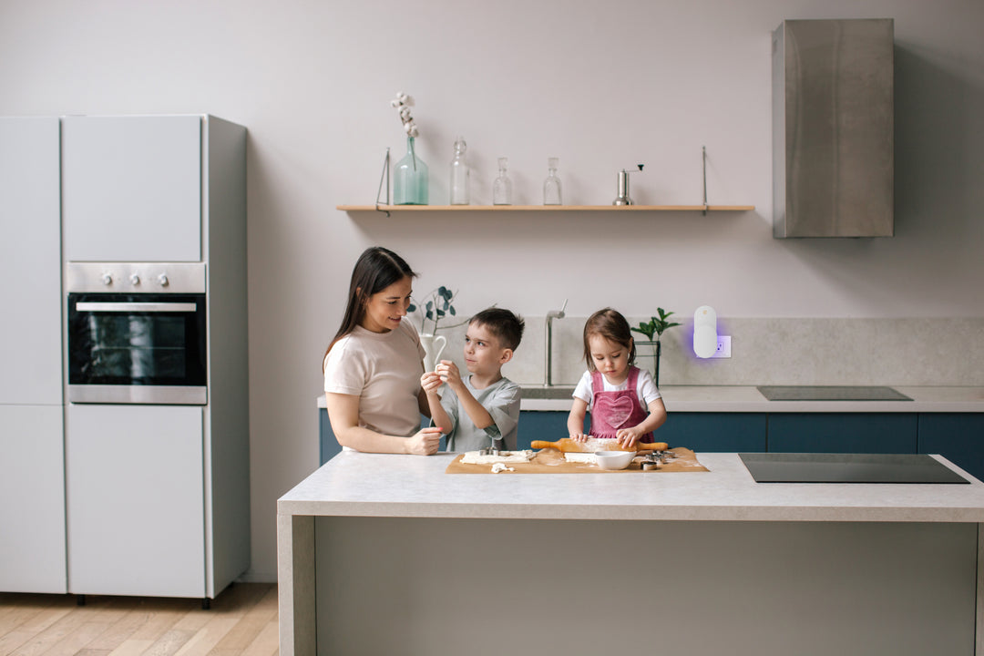 a person and kids sitting at a kitchen counter