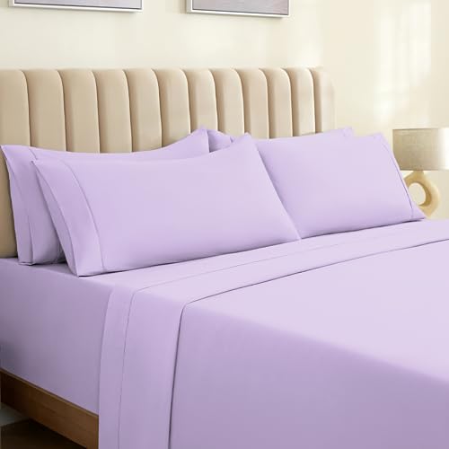 a bed with purple sheets