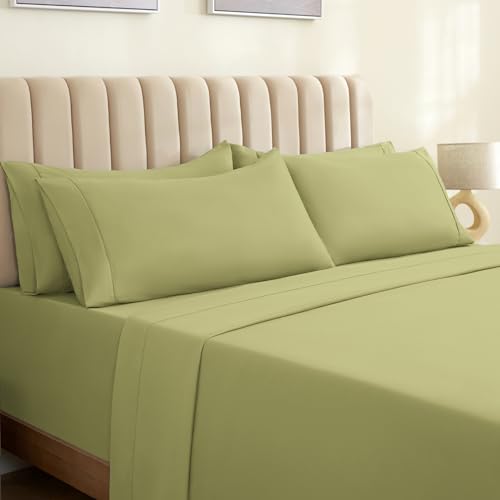 a bed with green sheets and pillows