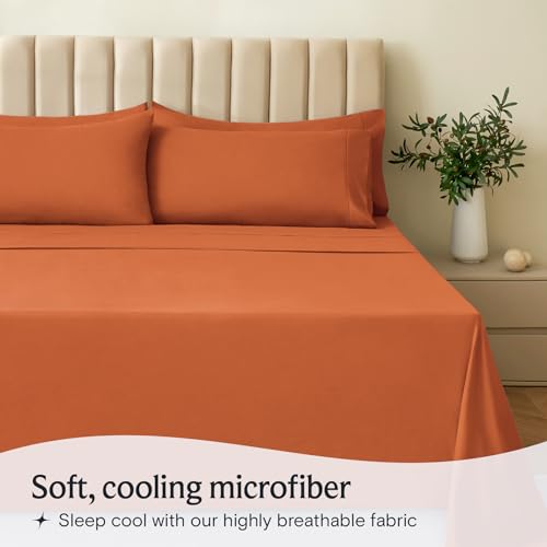 a bed with orange sheets and pillows with text: 'Soft, cooling microfiber Sleep cool with our highly breathable fabric'