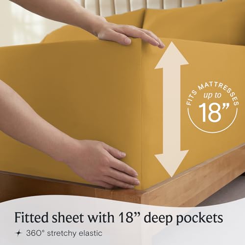 a person holding a box with a mattress with text: 'FITS 18' Fitted sheet with 18" deep pockets 360º stretchy elastic'