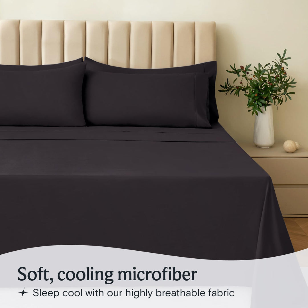 a bed with black sheets and pillows with text: 'Soft, cooling microfiber Sleep cool with our highly breathable fabric'