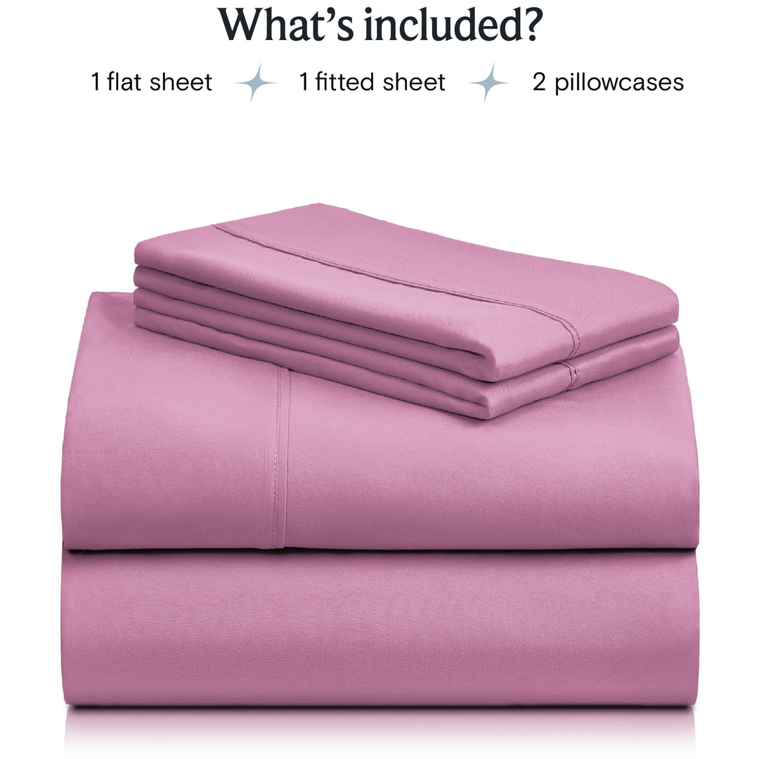 a stack of pink sheets with text: 'What's included? 1 flat sheet 1 fitted sheet 2 pillowcases'
