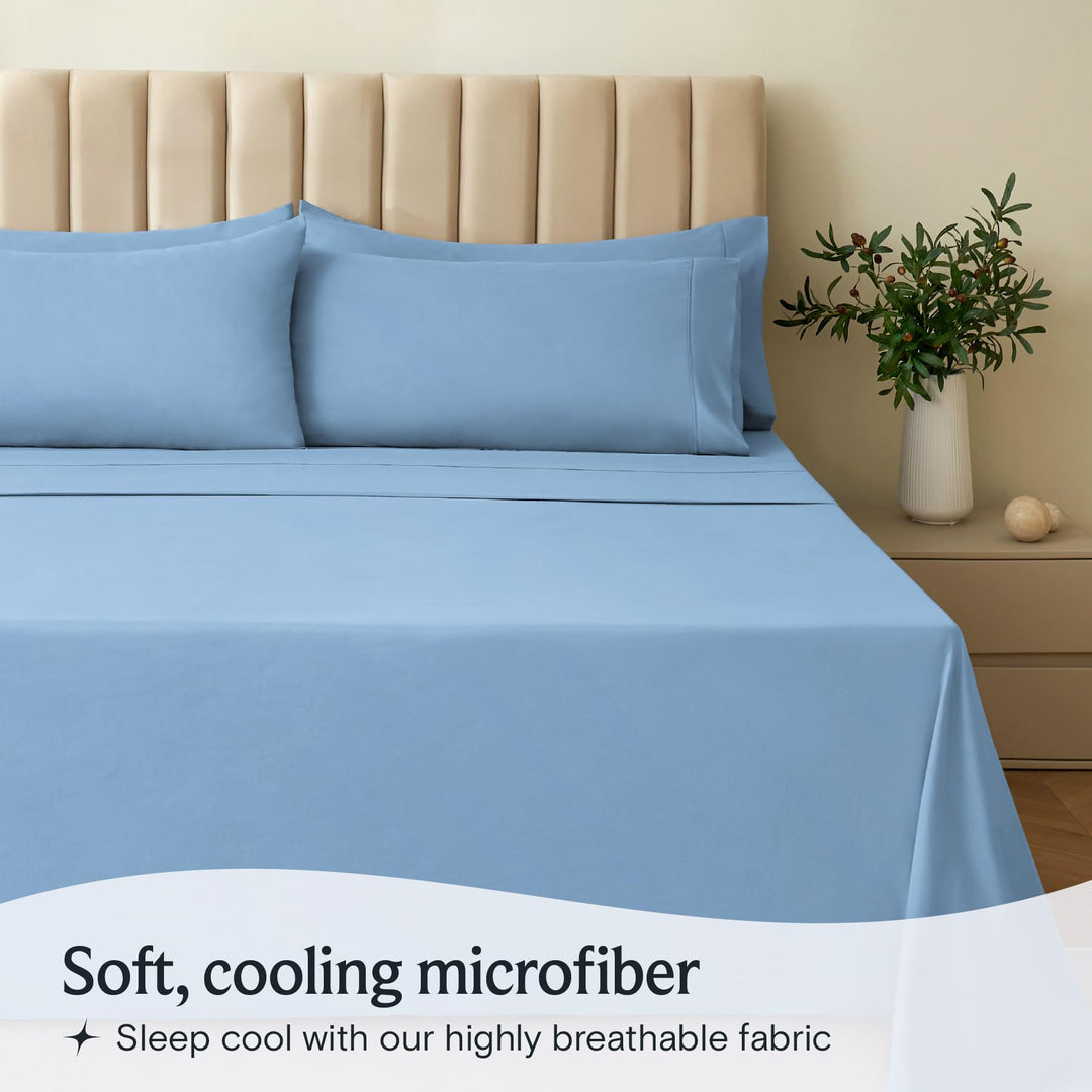 a bed with blue sheets and a vase of flowers with text: 'Soft, cooling microfiber Sleep cool with our highly breathable fabric'