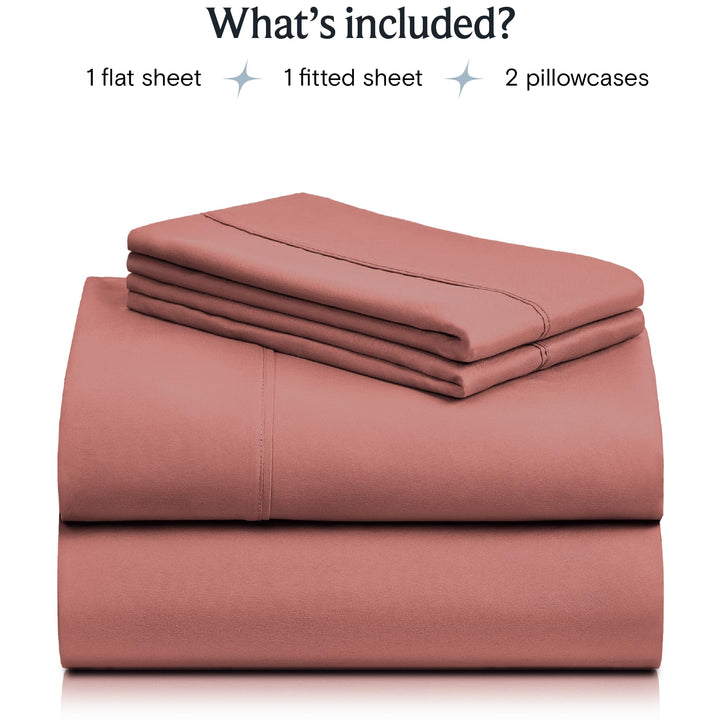 a stack of pink sheets with text: 'What's included? 1 flat sheet 1 fitted sheet 2 pillowcases'