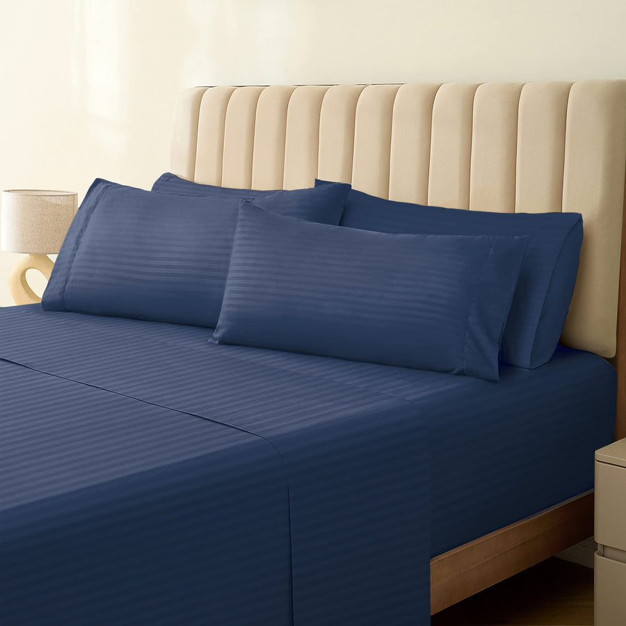 a bed with blue sheets and pillows
