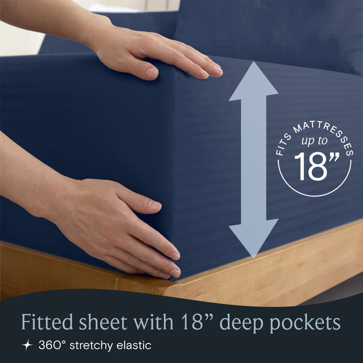 a person holding a blue box with text: 'RESSES up to FITS 18 Fitted sheet with 18" deep pockets 360º stretchy elastic'