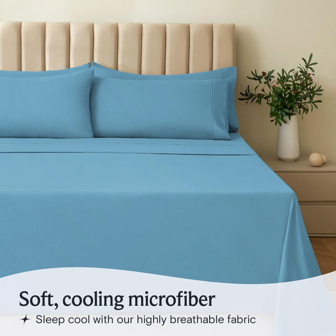 a bed with blue sheets and pillows with text: 'Soft, cooling microfiber Sleep cool with our highly breathable fabric'