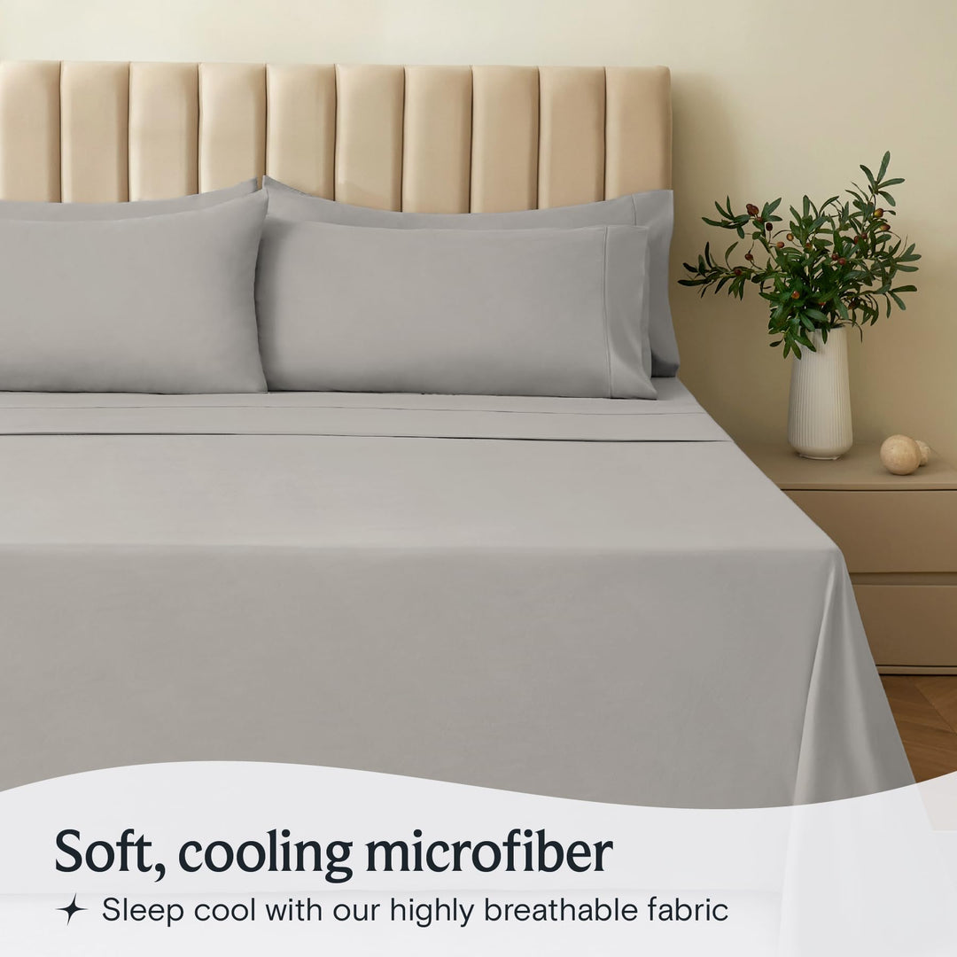 a bed with a vase of flowers with text: 'Soft, cooling microfiber Sleep cool with our highly breathable fabric'