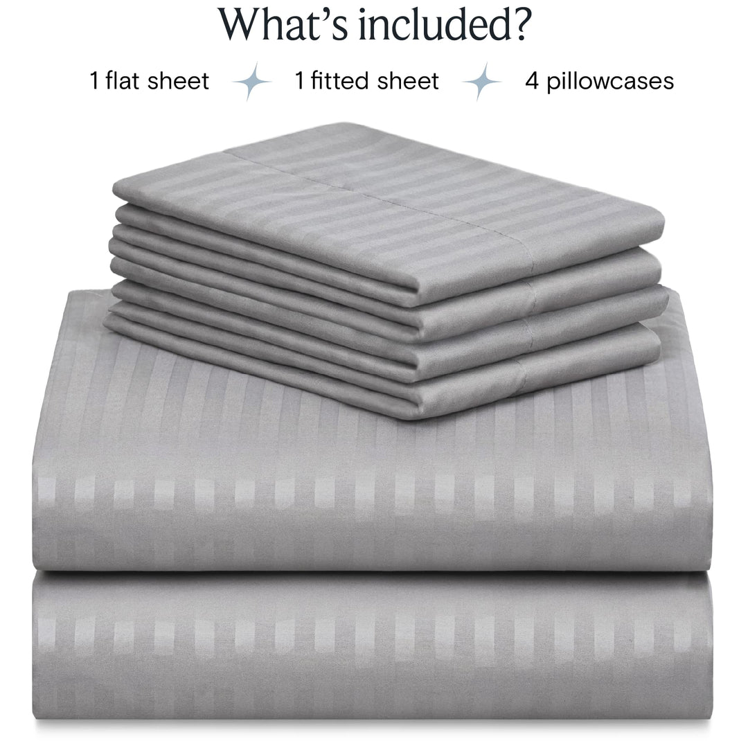 a stack of grey sheets with text: 'What's included? 1 flat sheet 1 fitted sheet 4 pillowcases'